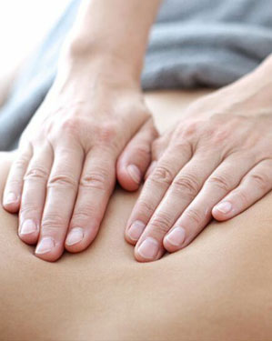 Two Hands Pressing a Back For Pain Relief